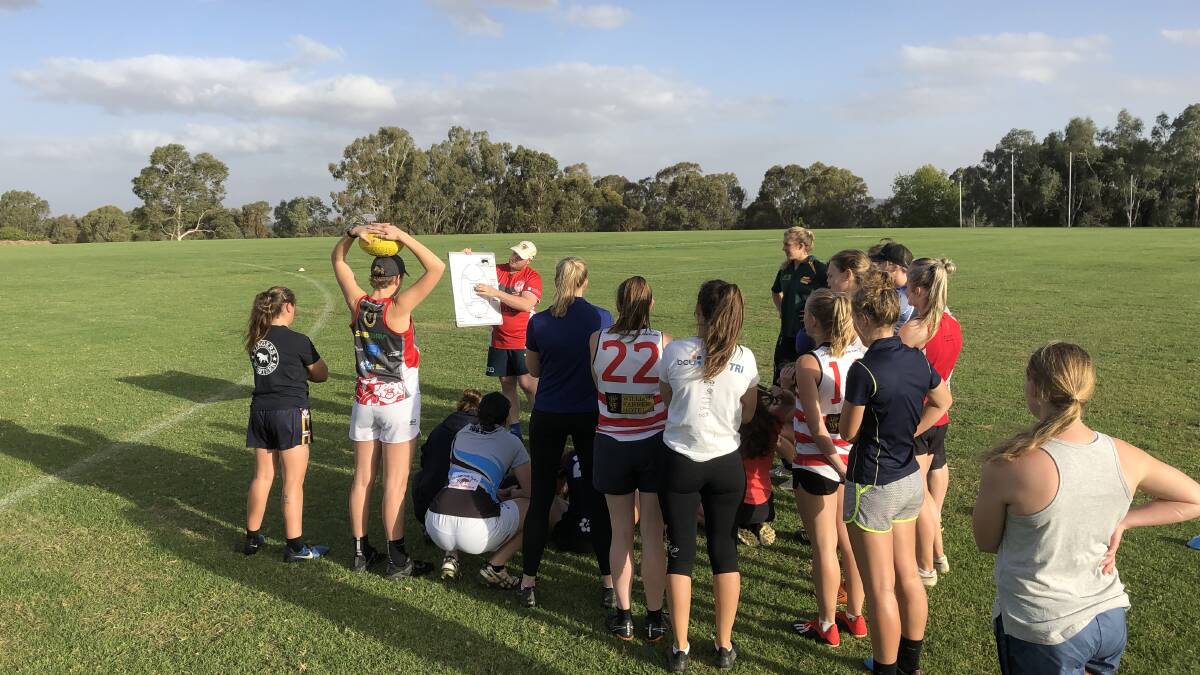 The Bushpigs listen up to coach Clinton Blake at training at Peter Hastie Oval this week. 