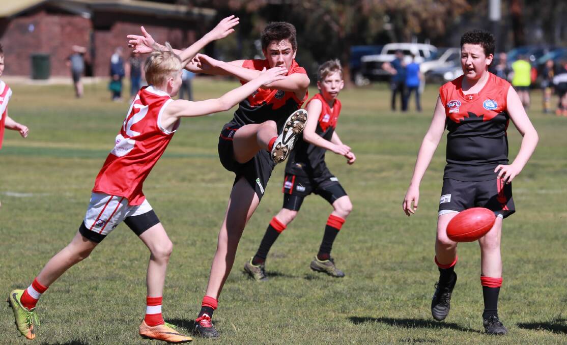 GET YA KICKS: Jake Hinds gets Wagga Swans going forward despite pressure from the Demons at Anderson Oval last week. Picture: Les Smith