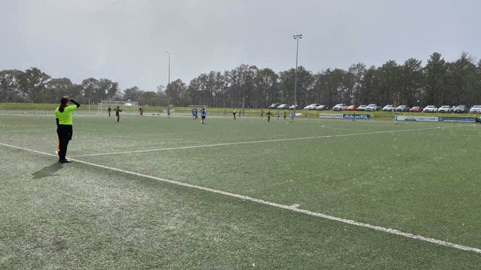 COOL START: Snow falling as the Wagga City Wanderers take on Belconnen United at Hawker on Saturday. Picture: Wagga City Wanderers