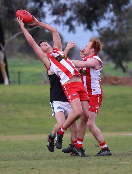 SWITCH UP: The move of Jack Thompson (taking a mark, alongside teammate Jake Raves) from defence to key forward is paying off, as he kicked another two goals in Saturday's win against the Northern Jets.