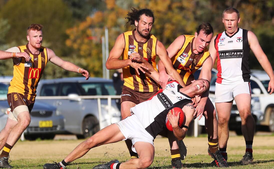 TOUGH BATTLE: North Wagga forward Troy Curtis has Hawks Max Tiernan (right) and Brocke Argus making life hard for him. Picture: Emma Hillier