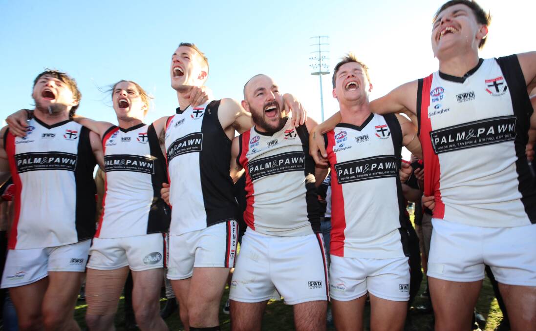 WINNERS' GRIN: Lachie Steward (centre) heads into retirement after the fourth senior premiership of his career. Picture: Les Smith