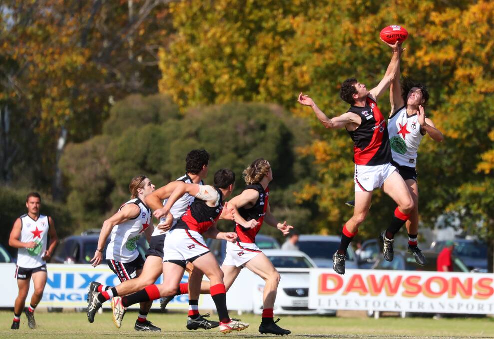 ROVING THE CONTEST: Midfielders hunt in a pack as Marrar's Nick Molkentin and Saint Ky Hanlon compete in the ruck at McPherson Oval. Picture: Emma Hillier