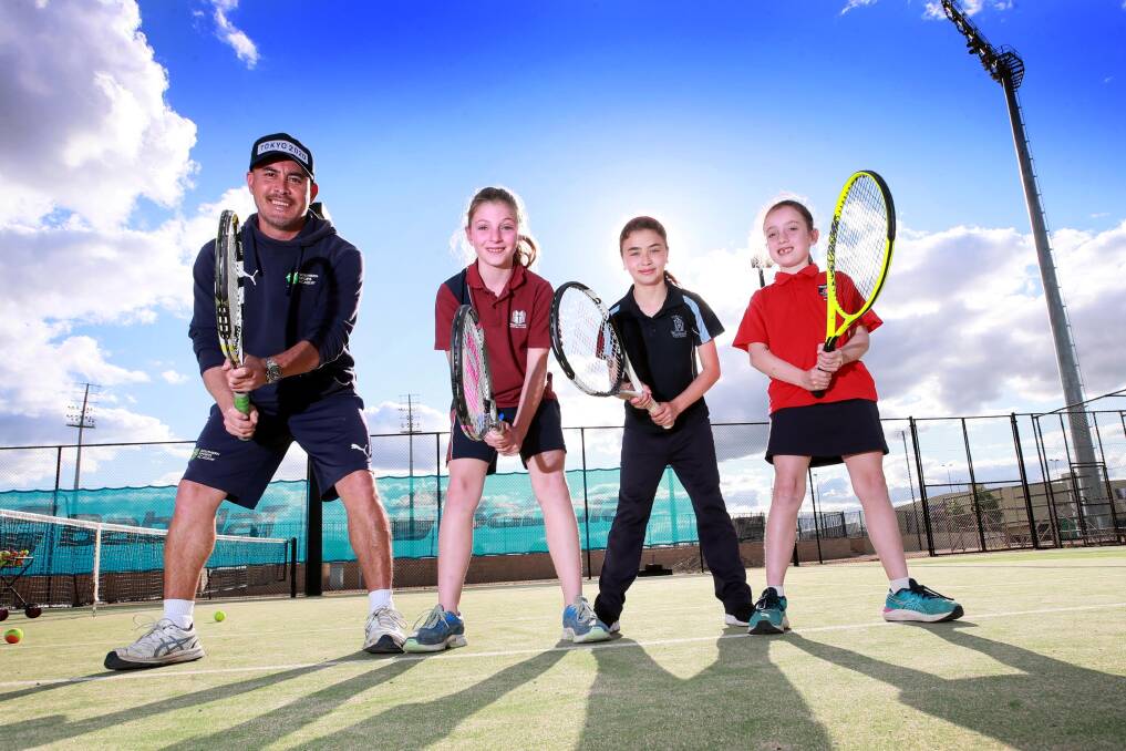 OUT OF COVID'S SHADOW: Tennis coach Tom Denahy with (from left) Zara Berrigan, 9, Charli Green, 10 and Gabbi Howard, 7, at the Jim Elphick Tennis Centre. Picture: Les Smith