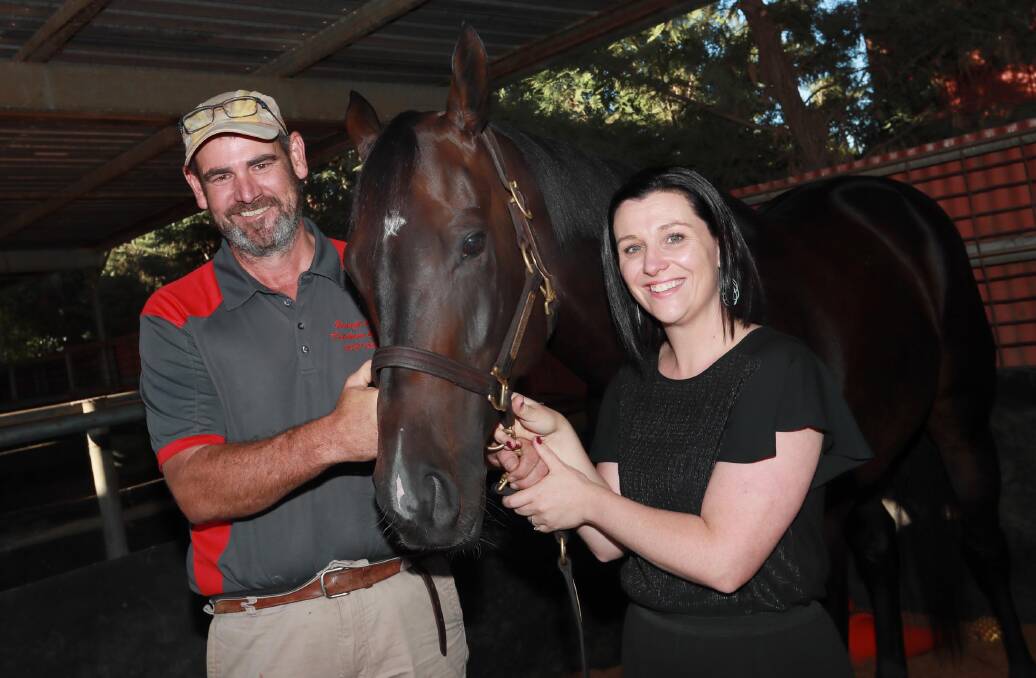 THRILL OF THE CHASE: Part owners George
and Amy Carroll with Blitzar on Friday.
Picture: Les Smith
