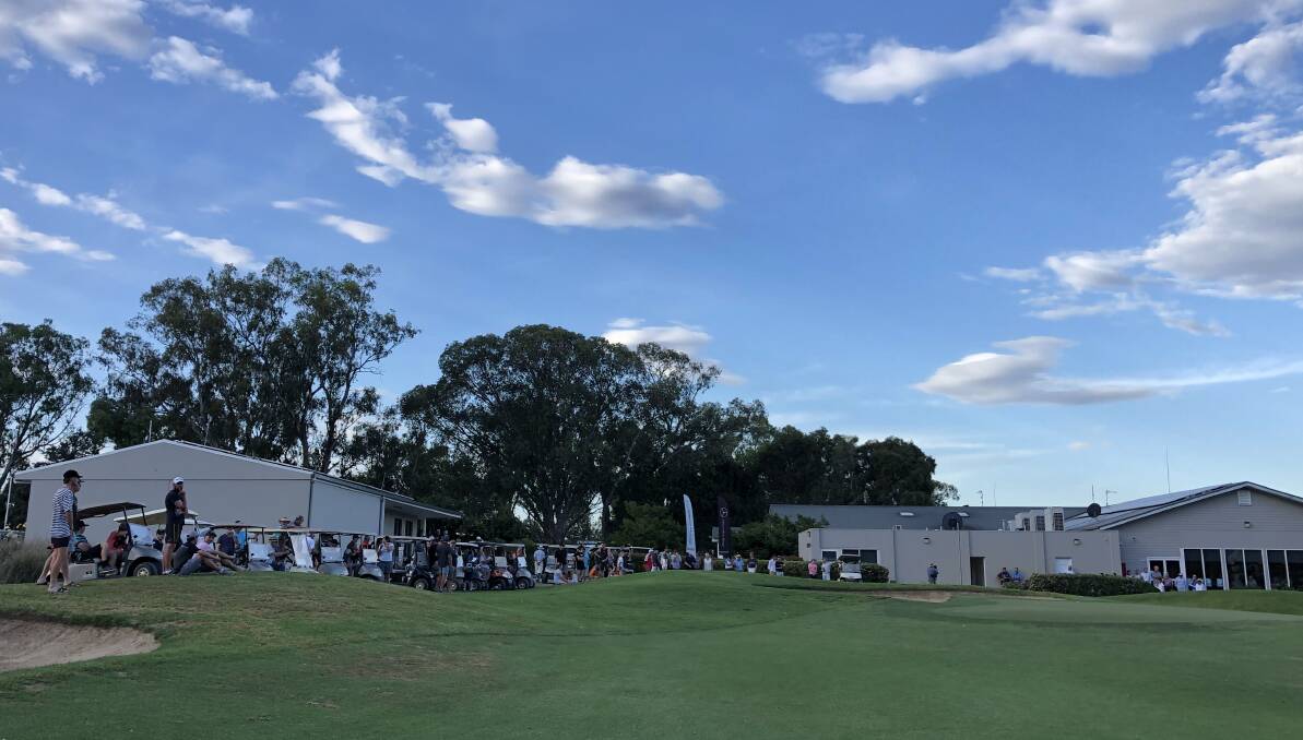 A strong crowd lines the ninth green for the playoff to decide the Wagga Country Club championship. Picture: Peter Doherty