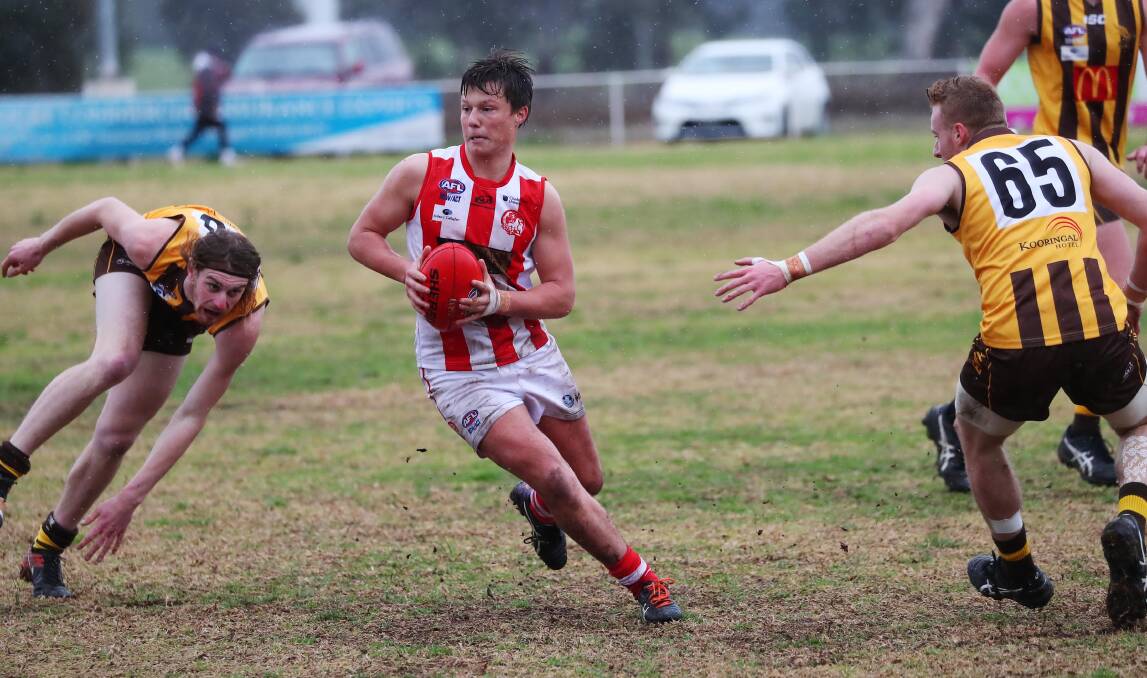 COMING BACK: Louis Miller threads a path through East Wagga-Kooringal defenders in CSU's loss to the Hawks at Gumly late in the season. Picture: Emma Hillier
