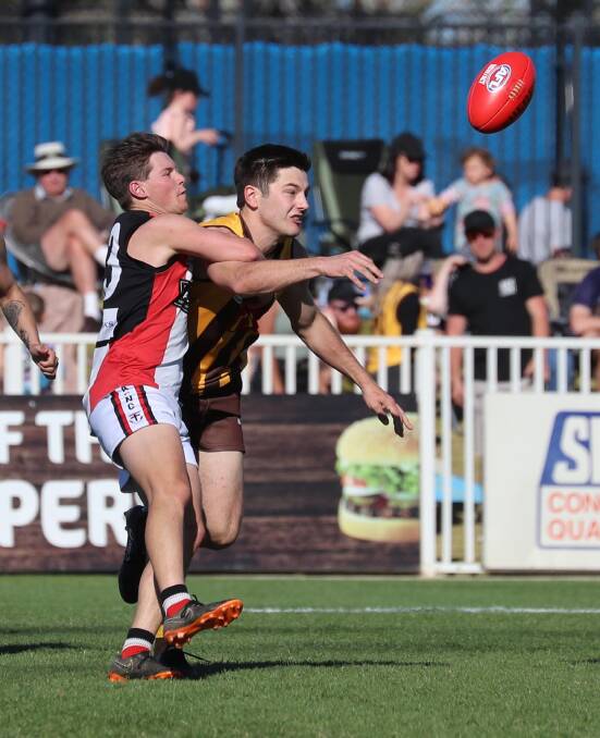 CLUB RIVALRY: Long-serving Saint Josh Thompson duels with EWK defender Nic Curran during last year's grand final. The win reversed a trend of finals losses to the Hawks. Picture:Les Smith