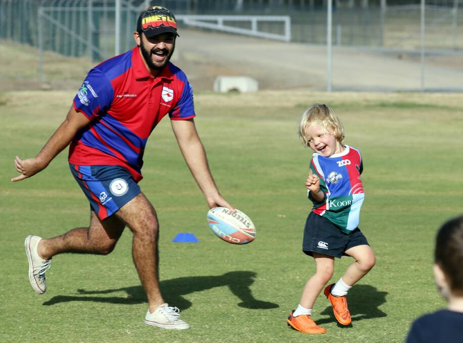 FUN INTO FUNDAMENTALS: Wagga Kangaroos junior coach Trae O'Neill tags Fred Skellern at their Under 6 training this week. Pictures: Les Smith