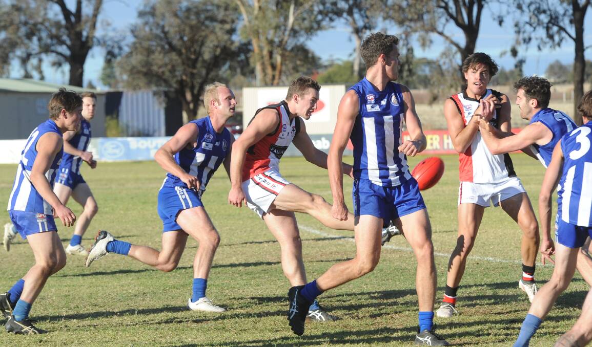 North Wagga midfielder Tom Bennetts gets a kick away at Temora in early June when the Saints dominated the Roos in the middle. Picture: Peter Doherty