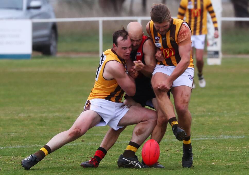 SANDWICHED: Marrar's Bryce Graetz is welcomed back to the Farrer League by East Wagga-Kooringal's Max Tiernan (left) and Kade Rowbotham. Picture: Emma Hillier