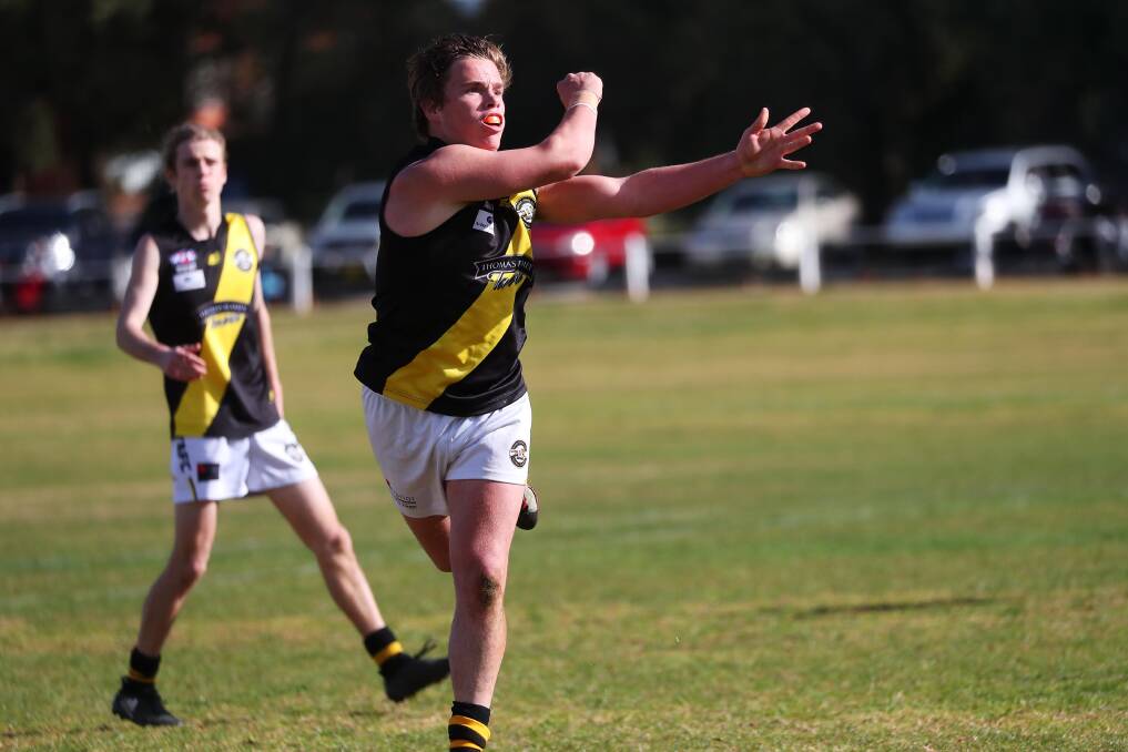 Jeffery Mannell fires out a handball for Tigers against Coolamon last year.