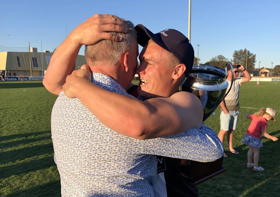 AT LONG LAST: North Wagga coach Kirk Hamblin embraces life member and former president Peter Keating who was instrumental in keeping the club alive after it went into recess in 2007. Picture: Peter Doherty