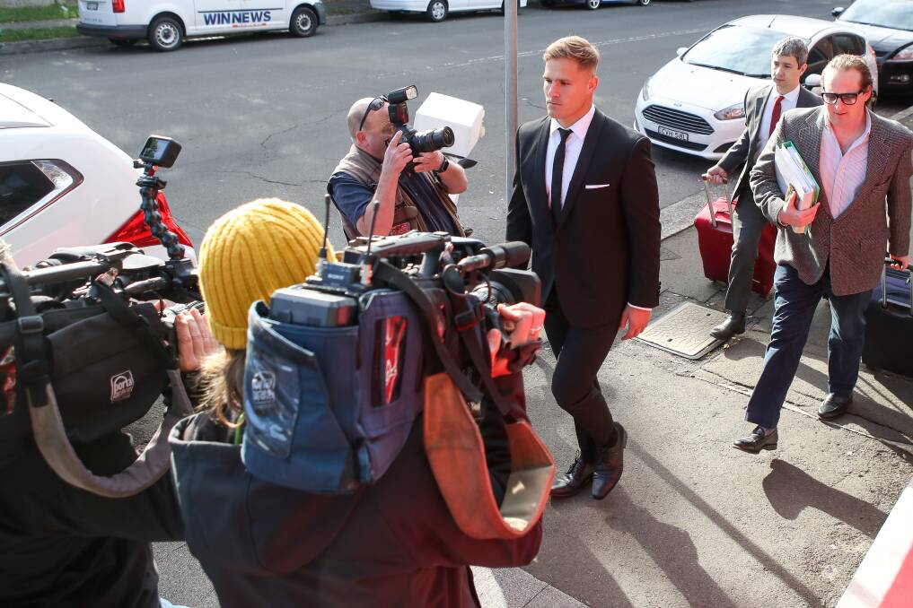 A different kind of scrum: Jack de Belin is greeted by a contingent of media as he arrives at Wollongong court on Monday for the continuation of his pre-trial hearing. Picture: Adam McLean