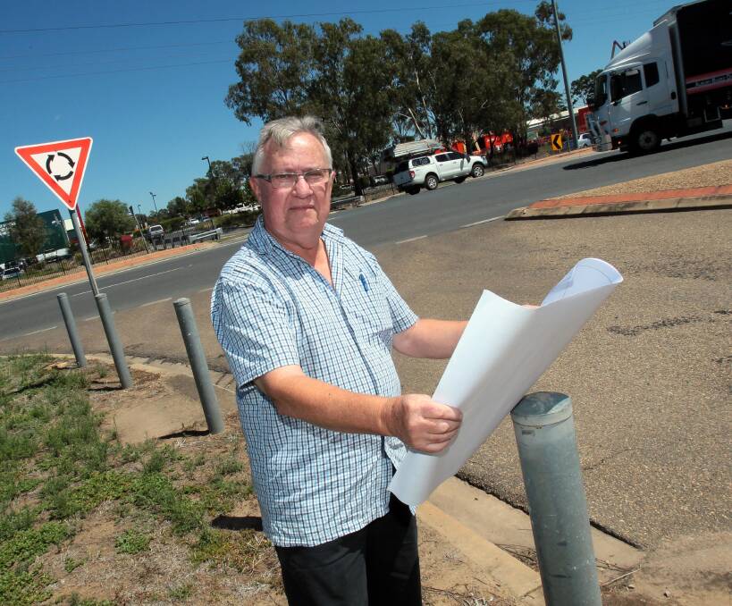 GO TIME: Tim Brennan displays plans for a new Dobney Avenue 24-hour service station at the northern entrance. He says the $1.5 million development will not affect traffic flow through the busy double roundabouts. Picture: Les Smith 