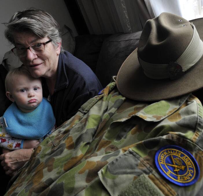 HONOURED: Jan Bourke is up for the Australian of the Year accolade, nominated for her 22-year service with Wagga's Australian Army Cadets. Grandson (left) Joseph Cowell, 15 months, is pretty impressed. Picture: Les Smith 