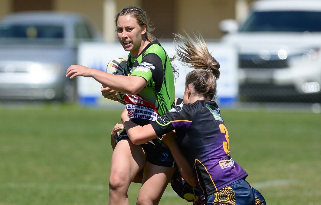 Albury Thunder's  Lauren Dam attempts to break a tackle against Central Storm at Greenfield Park on Sunday. Picture: MARK JESSER