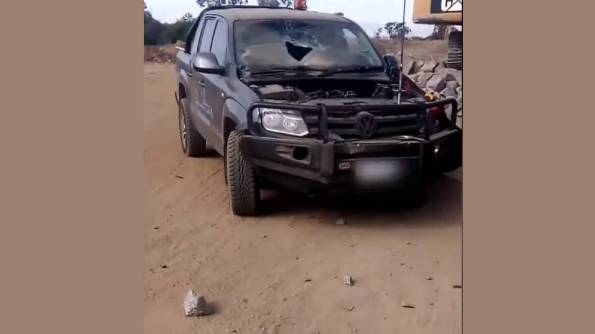 DAMAGE: Large rocks can be seen near a Volkswagen Amarok, which had its bonnet and windscreen damaged after being struck during the explosion. 