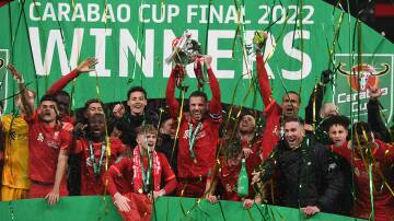 Liverpool captain Jordan Henderson lifts the English League Cup trophy aloft in February. Picture: AAP