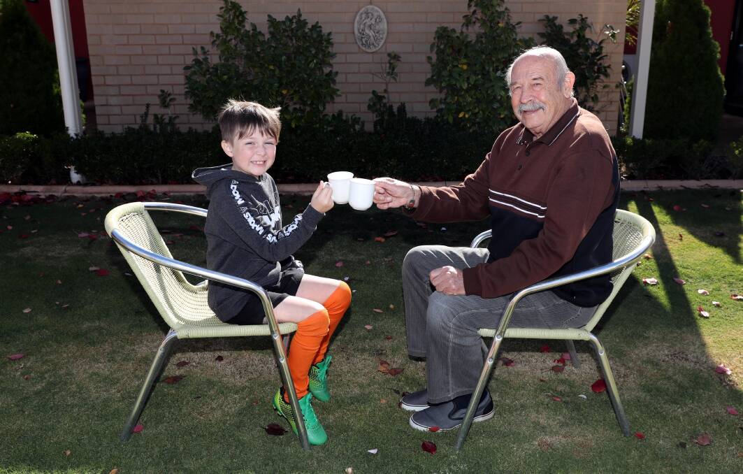 Sweet tea: Oura boy Nate Thomas, 8, with his granddad, Ray Johnstone at the Settlers Village Biggest Morning Tea on Saturday. Picture: Les Smith 