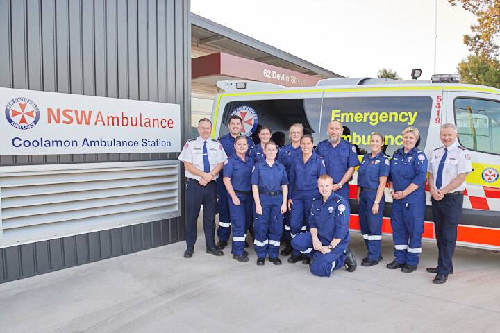 Team effort: Coolamon's paramedics and qualified volunteer ambulance officers with NSW Ambulance commissioner Dominic Morgan (left) and senior assistant-commissioner David Dutton (right).

