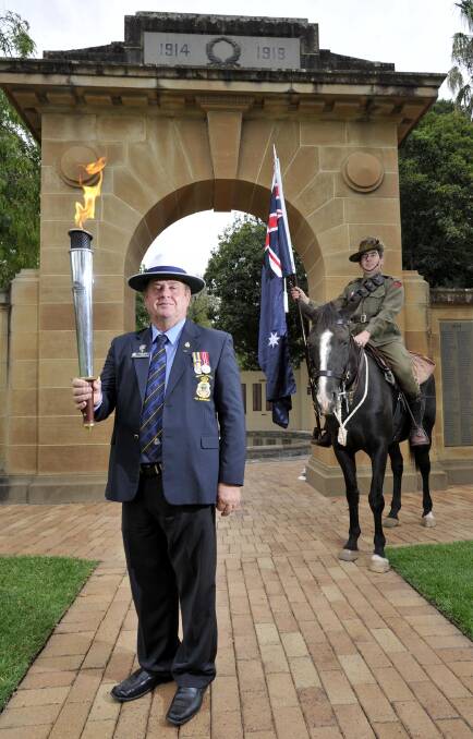 Holding the flame: Wagga RSL Sub Branch treasurer Brian Watts with Connor McComas on Jasmine at Victory Memorial Gardens, where the dedication will be held. 