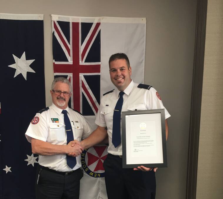High honour: NSW Ambulance operations deputy-director Brian White awards Wagga paramedic Tim Scott-Young with a Commissioner's Unit Citation.