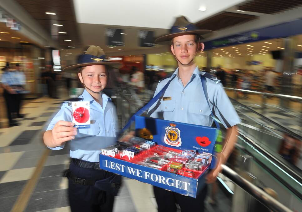 Lest we forget: Phoebe Torres, 13, and Blake McCrea, 15, from 332 Squadron selling poppies at the Marketplace ahead of Remembrance Day 2016. 