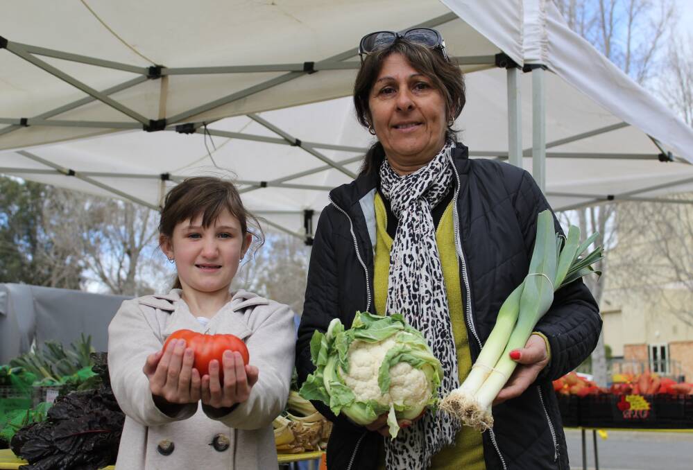 To market: Spout and About stall holder and Cobram farmer Maria Verduci - with helper Ashleigh Anderson, 9 - said buying produce at a local market kept Australian farmers farming. 