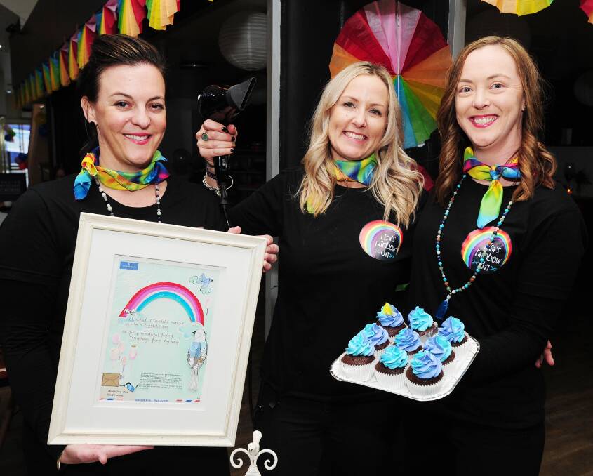 Colourful memories: Beloved hairdresser Lisa Hill's daughters Anna Worland and Gina Hill with Tammie Wilson. Picture: Kieren L Tilly 