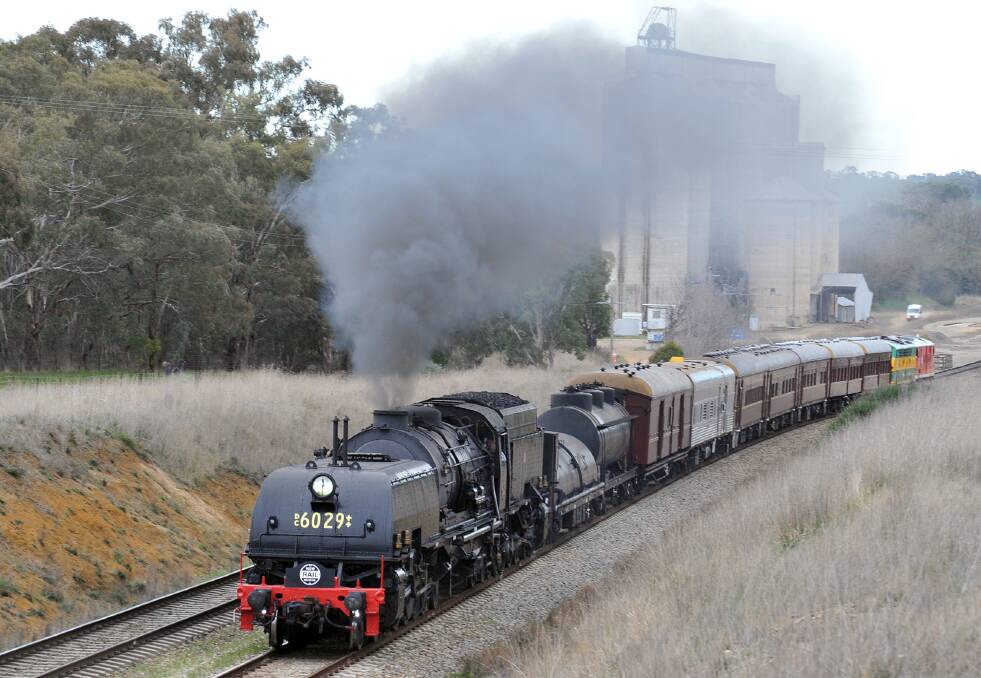 ALL ABOARD: The Garratt at the head of the tour train as it leaves Wallendbeen. Note the historic diesels attached at the rear.