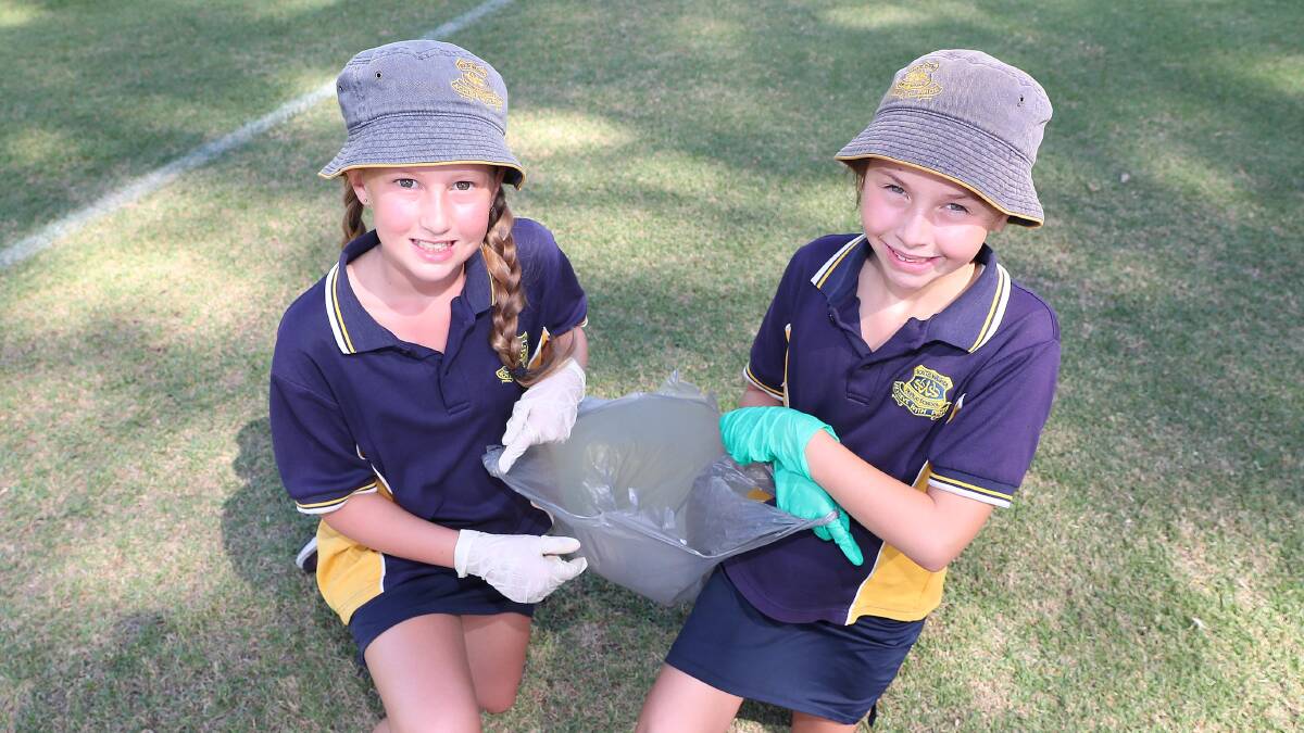 TIDY TEAM: Ten-year-olds Lucy Croker and Caity Jay, from South Wagga Public School, get into the Clean Up Australia spirit. Picture: Kieren L Tilly