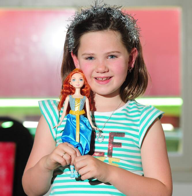 FESTIVE: Gabrielle Bryce, 7, of Wagga, at the Country Hope Christmas party at the MTC with her doll from the movie Brave. Picture: Kieren L Tilly