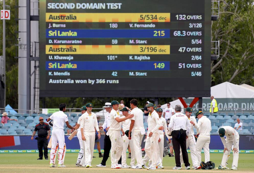 GOOD VENUE: Australian players celebrate after winning the test match and series on day four of the second Test match between Australia and Sri Lanka at Manuka Oval in Canberra on Monday.