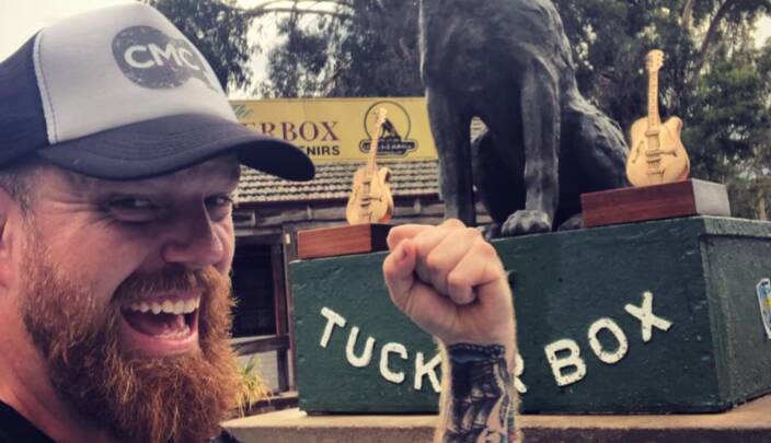 Double delight: Andrew Swift with his Golden Guitars and the Dog on the Tuckerbox after tasting success at the Tamworth country music festival in January. 