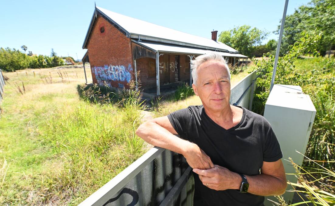 Barry Young in front of the graffiti-covered former railway workers' barracks which he would like to see used for a hospitality enterprise. Picture by Mark Jesser