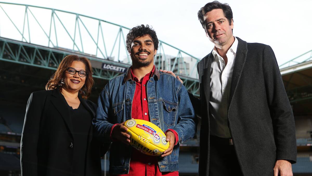 Welcome move: AFL general manger inclusion and social policy Tanya Hosch and AFL chief executive Gillon McLachlan congratulate Tony Armstrong on his elevation to the Triple M ball-by-ball team. Picture: MARTIN KEEP/AFL PHOTOS