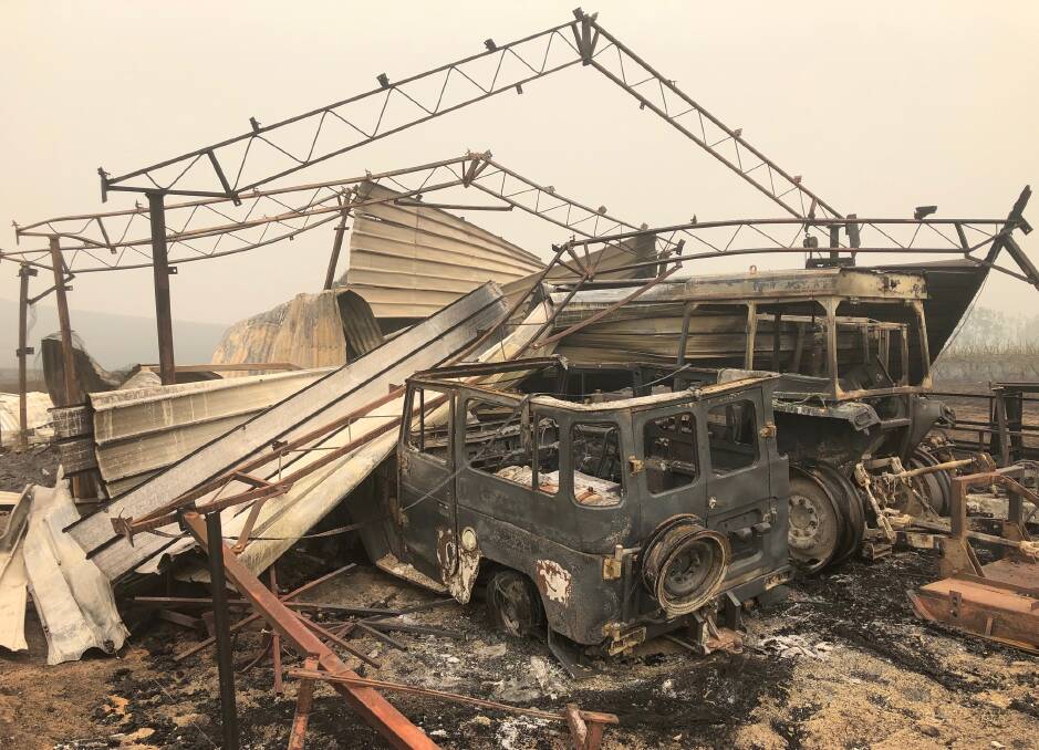 Wreckage: Vehicles were left shells and the shed housing them collapsed as fire tore through Maragle north of Tooma on New Year's Eve. Picture: VANESSA KEENAN 