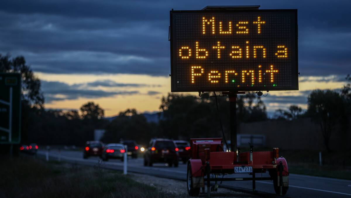 Warning up: A temporary sign placed along the Hume Freeway in South Albury warning motorists from the wider NSW of their entry requirements.