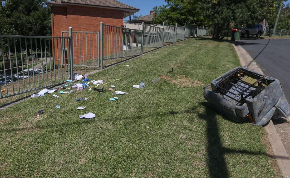 Aftermath: Debris linked to the woman who spooked a unit complex was spread across the nature strip in front of the Pulwarra Place flats in Thurgoona Street on the western edge of central Albury. Picture: TARA TREWHELLA