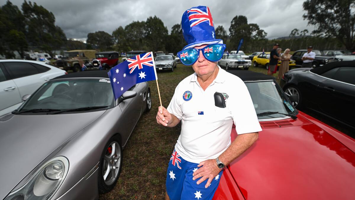 Thurgoona's Alan Brink had the flag clobber down pat after bringing his 1980 Alfa Romeo Spider for an Australia Day car display at Wymah. Picture by Mark Jesser