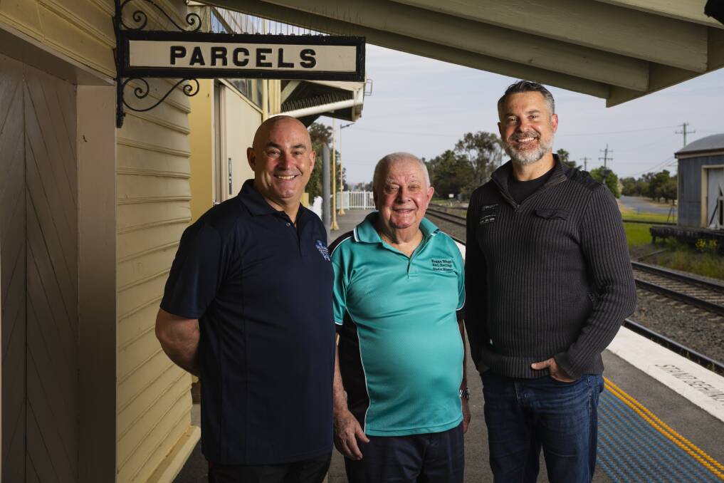 Gerard, Peter and Graeme Simpfendorfer stand on the platform of Henty railway station near the parcel room, a work area for their forebear Fred Simpfendorfer. Picture by Ash Smith