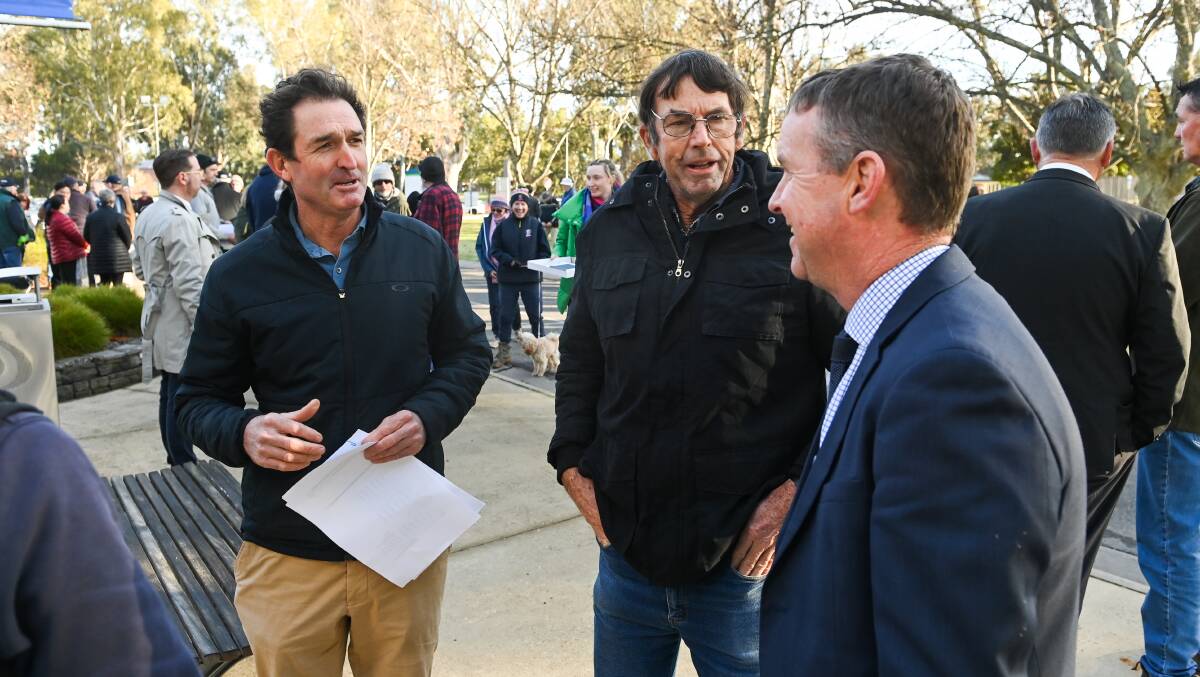 Flashback: Federation Ratepayers committee members David Bott and Rob Pearce look at Federation Council general manager Adrian Butler during their protest outside the Corowa council offices in June. Picture: MARK JESSER