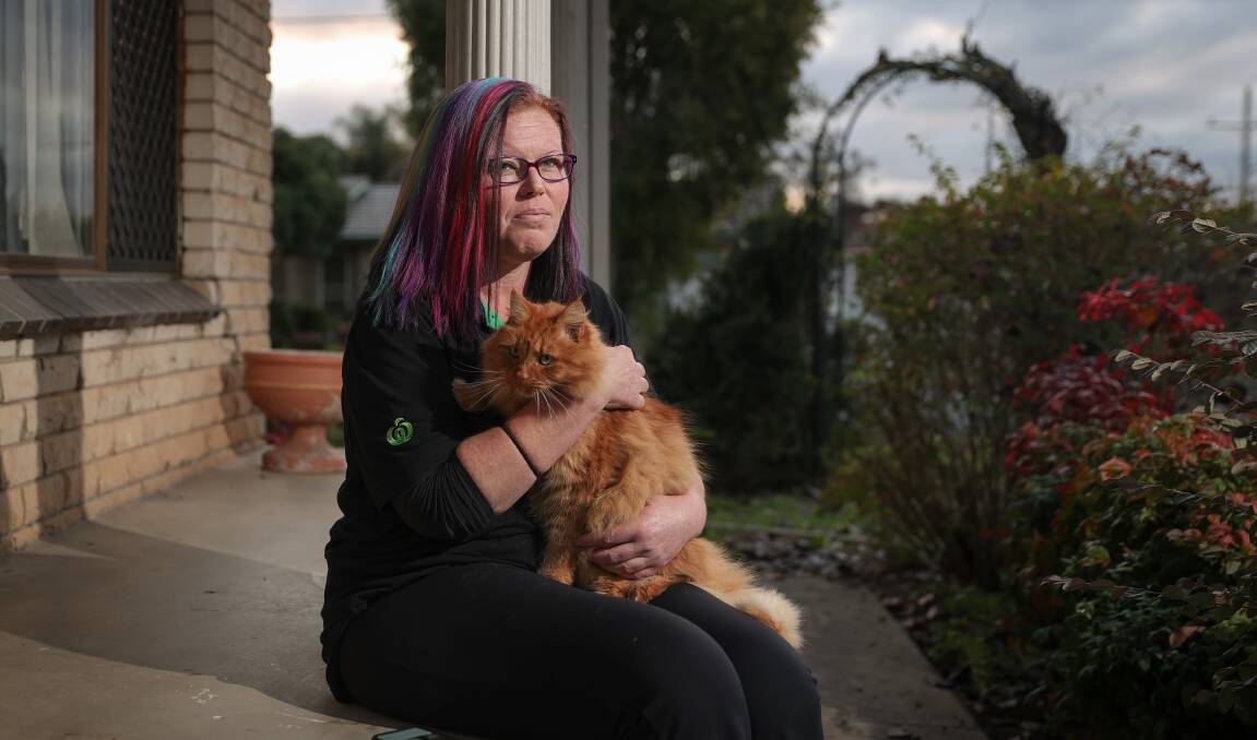 Annoying wait: Cassie Metcalfe at home with her pet cat Simba. She has been left in limbo waiting for a surgical remedy to her gallstones pain. Picture: JAMES WILTSHIRE