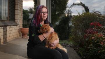 Annoying wait: Cassie Metcalfe at home with her pet cat Simba. She has been left in limbo waiting for a surgical remedy to her gallstones pain. Picture: JAMES WILTSHIRE