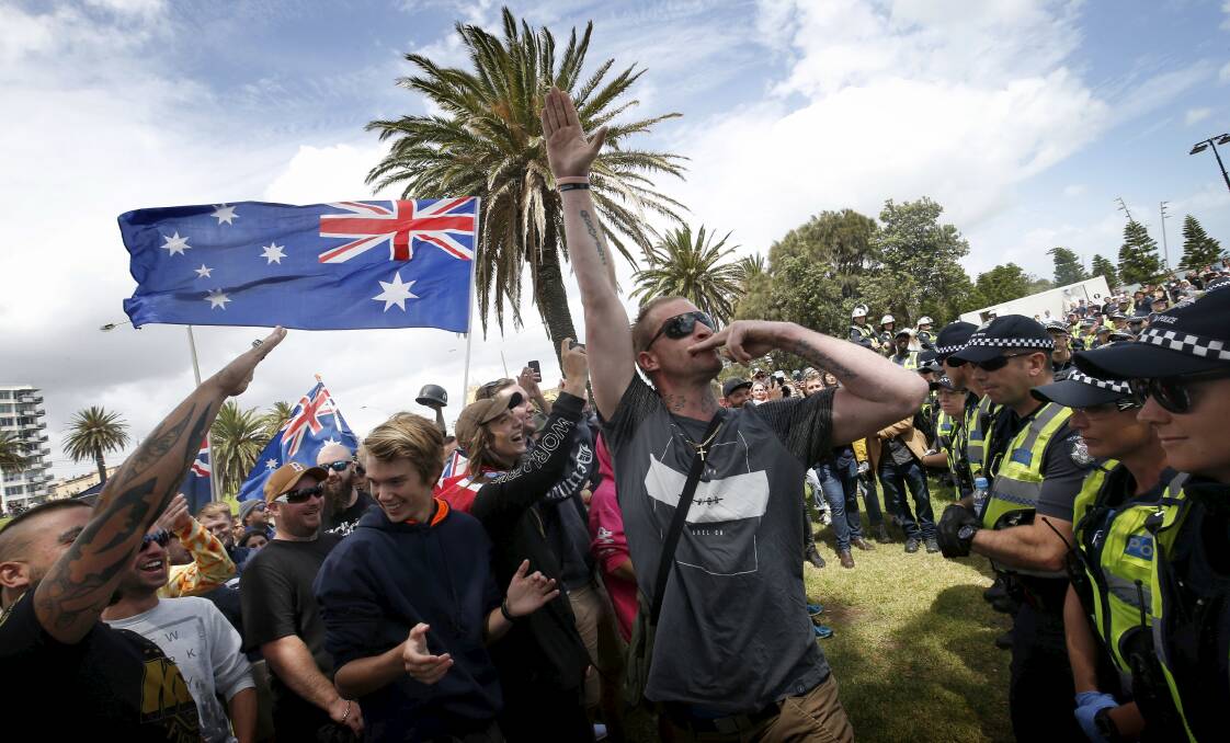 Repugnant: A protester displays the Nazi salute in front of a cordon of police at St Kilda.