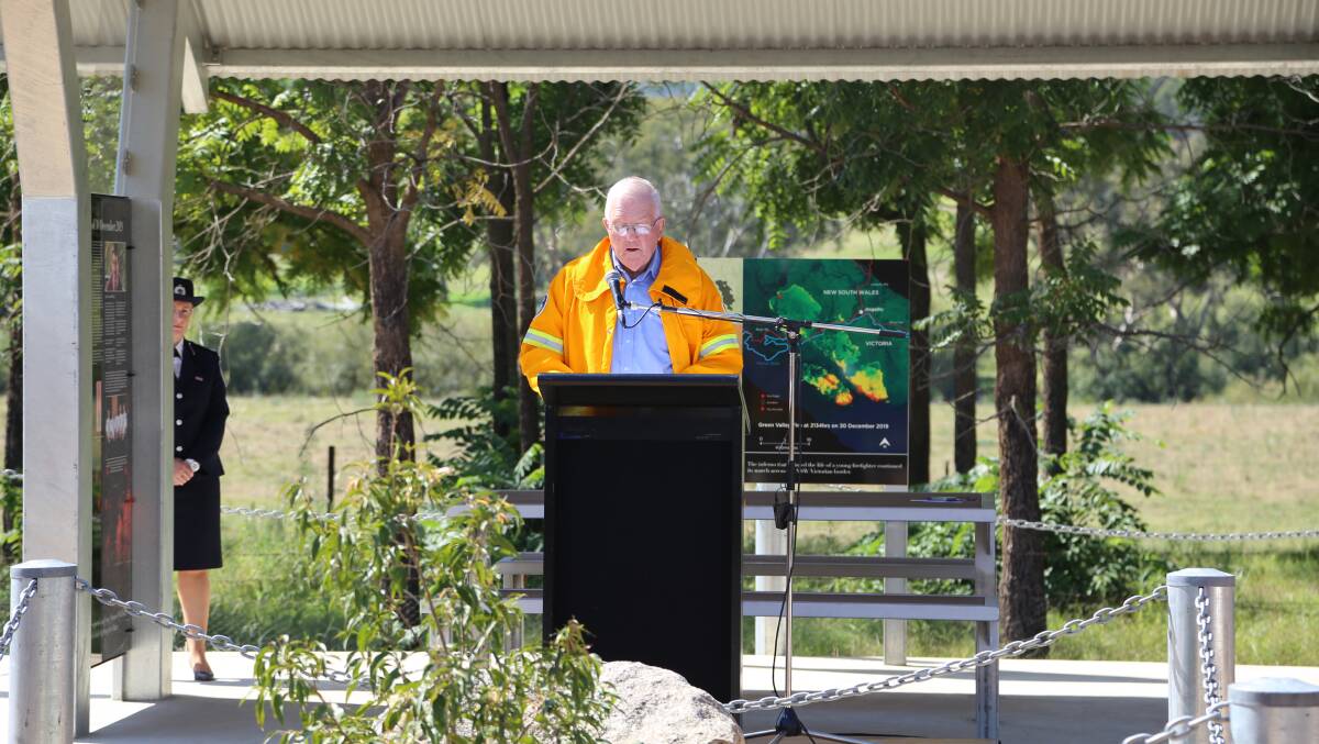 Reflecting: Greater Hume mayor Tony Quinn in his Gerogery RFS jacket speaks in front of a map showing the fire's path.