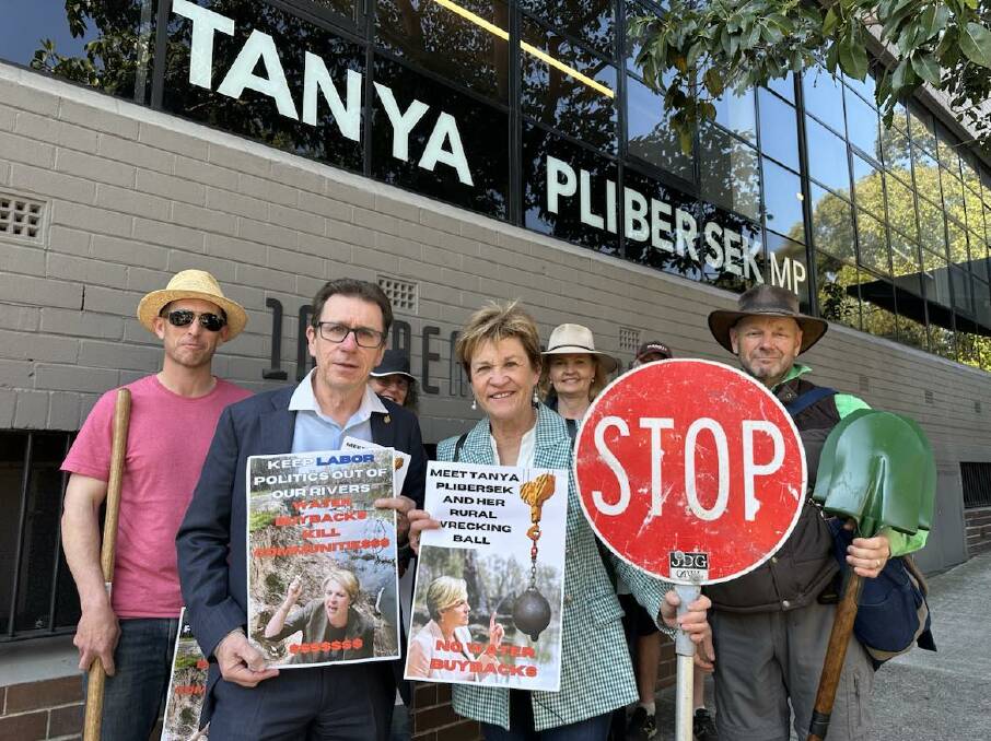 NSW politicians Joe McGirr and Helen Dalton with supporters outside Environment Minister Tanya Plibersek's office in Sydney. The 'stop' sign was given to Mrs Dalton by a roadworker who is an admirer of her stance. Picture supplied. 