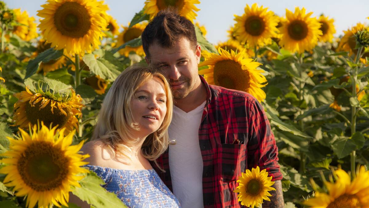 SAFETY: Inna and Yurii Chuchenko visited the sunflowers in the Liverpool Plains, the national flower of Ukraine. Photo: Mark Chapple