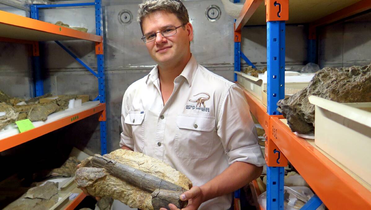 GREAT FIND: Dr Stephen Poropat with a fragment of the new dinosaur fossil. Photo: Contributed